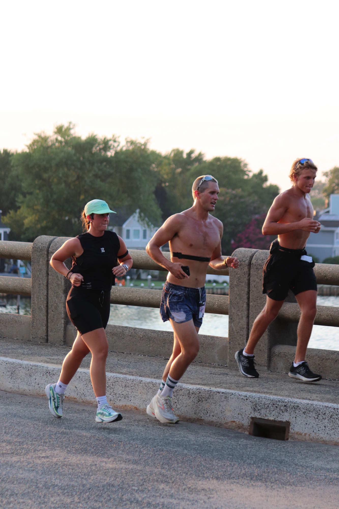 Golden-hour training run across a bridge with two training partners